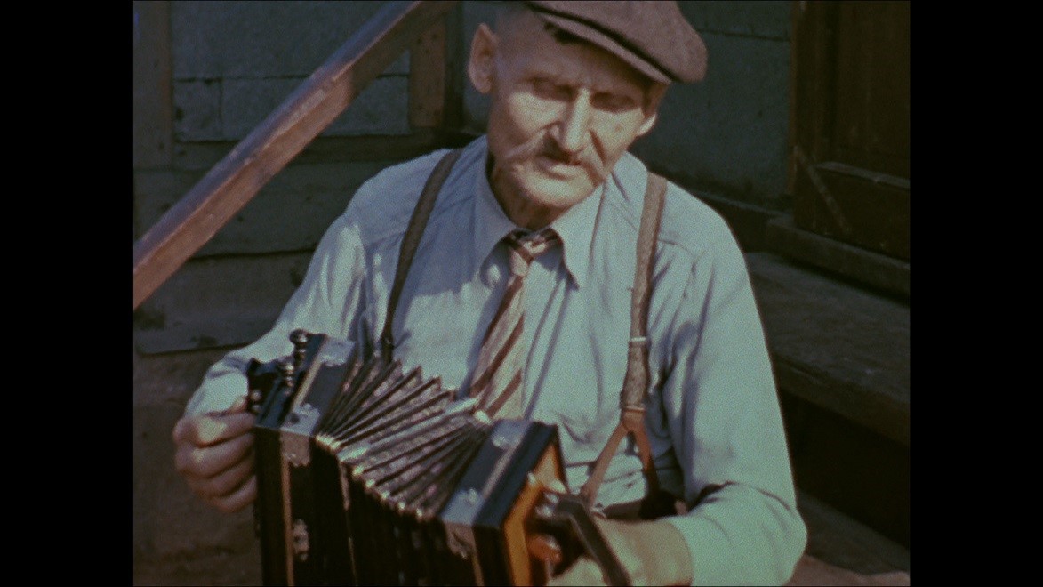 Aapo Juhani playing concertina in a still from Alan Lomax’s color film footage, Calumet, Michigan, 1938.