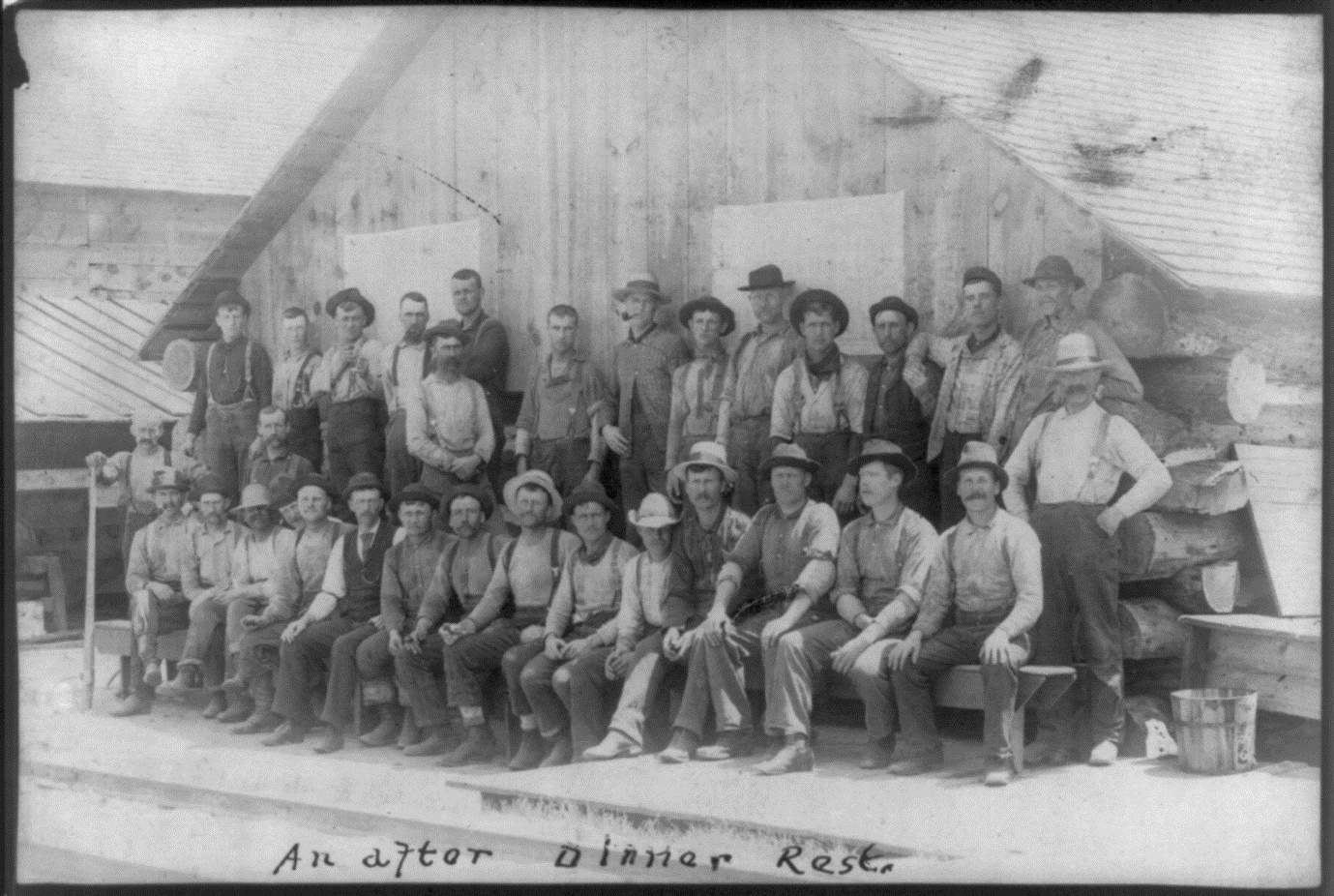 Michigan lumberjacks posing in front of their shanty or bunkhouse.